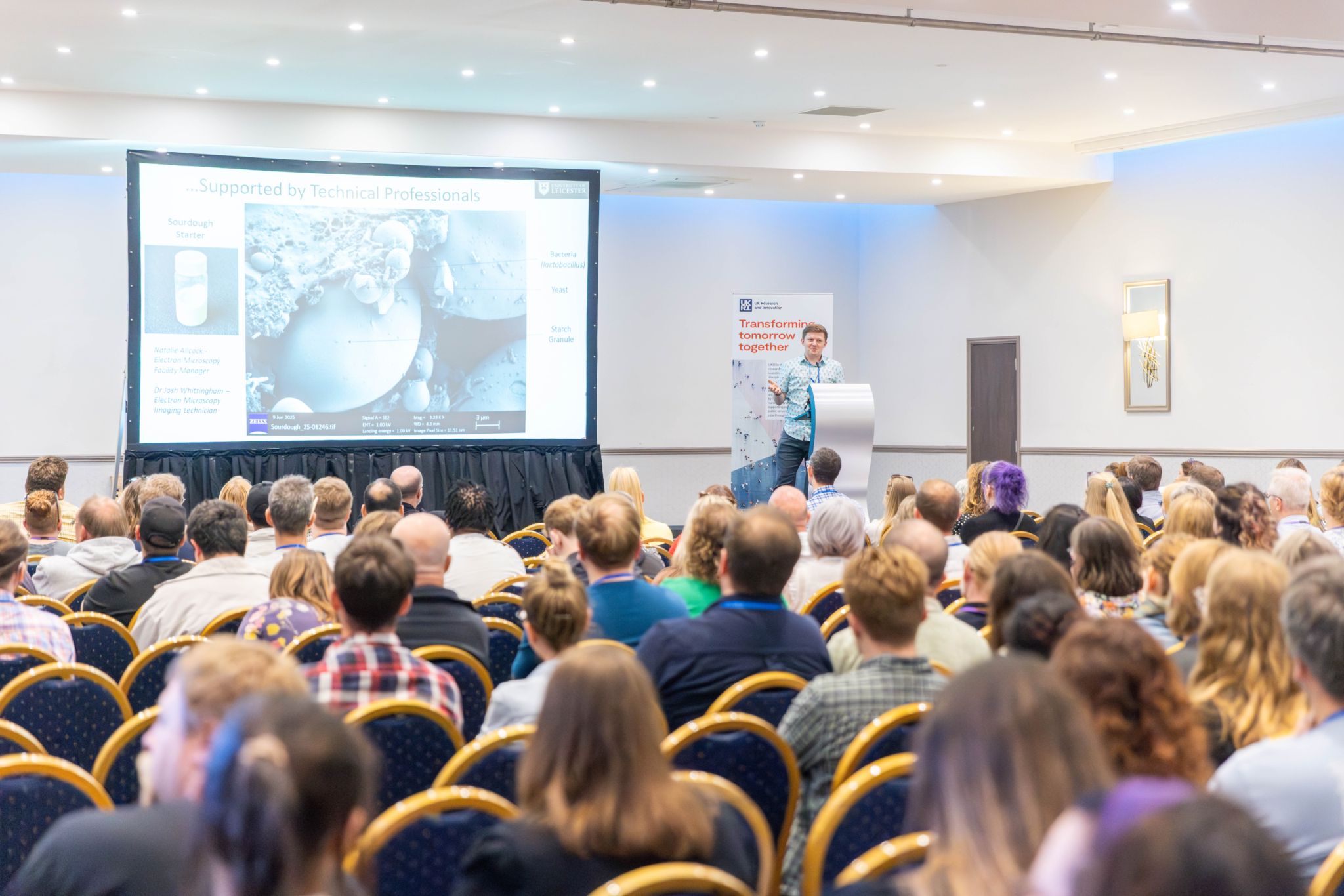 Technicians listen to keynote speaker, Dr Josh Smalley, at HETS 2025