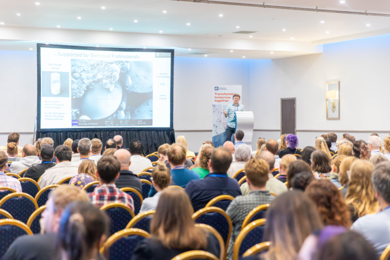 Technicians listen to keynote speaker, Dr Josh Smalley, at HETS 2025