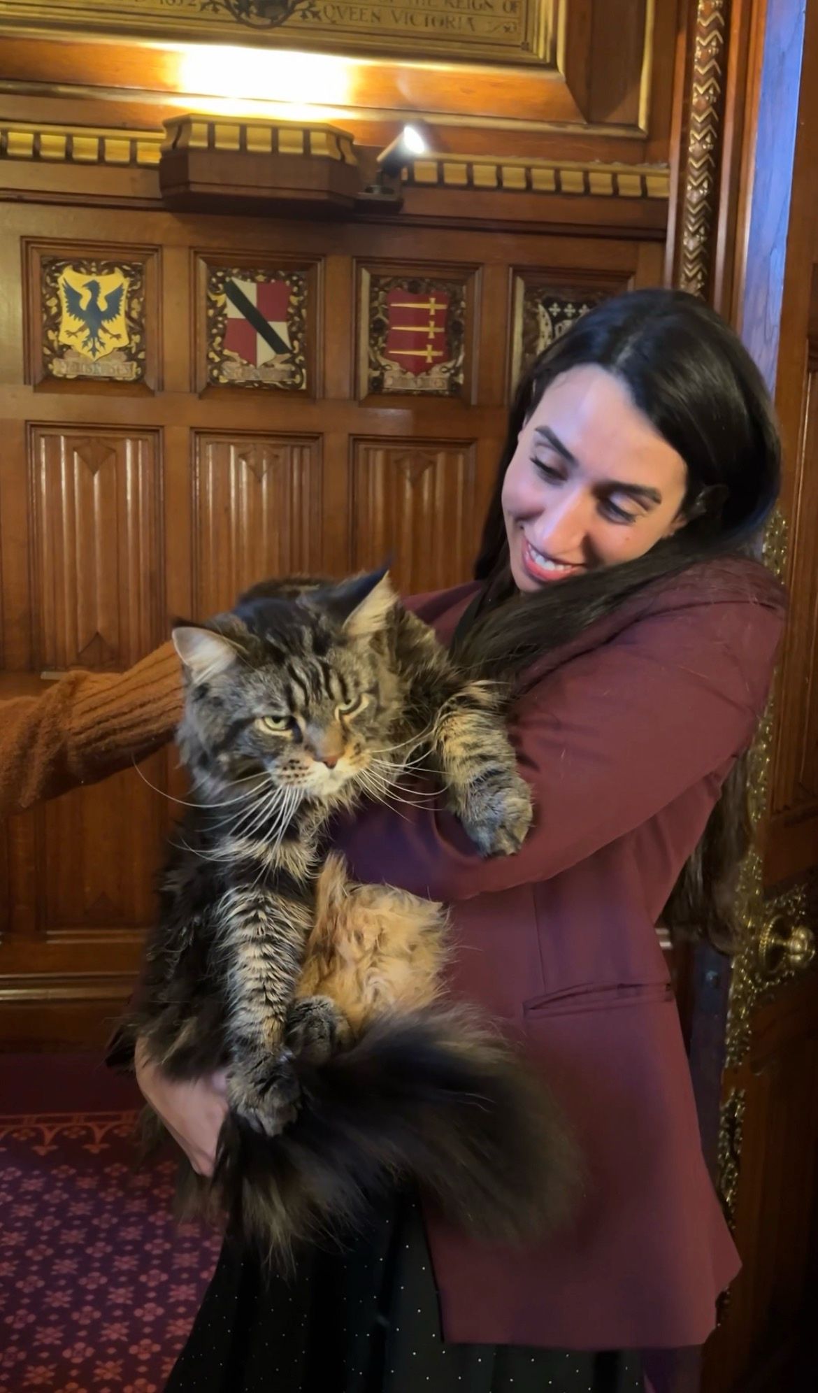 Lady, smiling, holding a cat