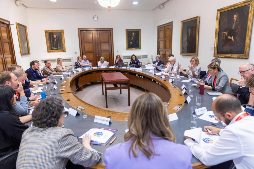 Pictured are a group of people around a round table at a meeting at the UK Global R&D and Science Investment Summit