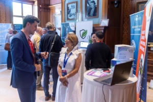 Attendees networking at the UK Global R&D and Science Investment Summit with exhibition banners in the background.
