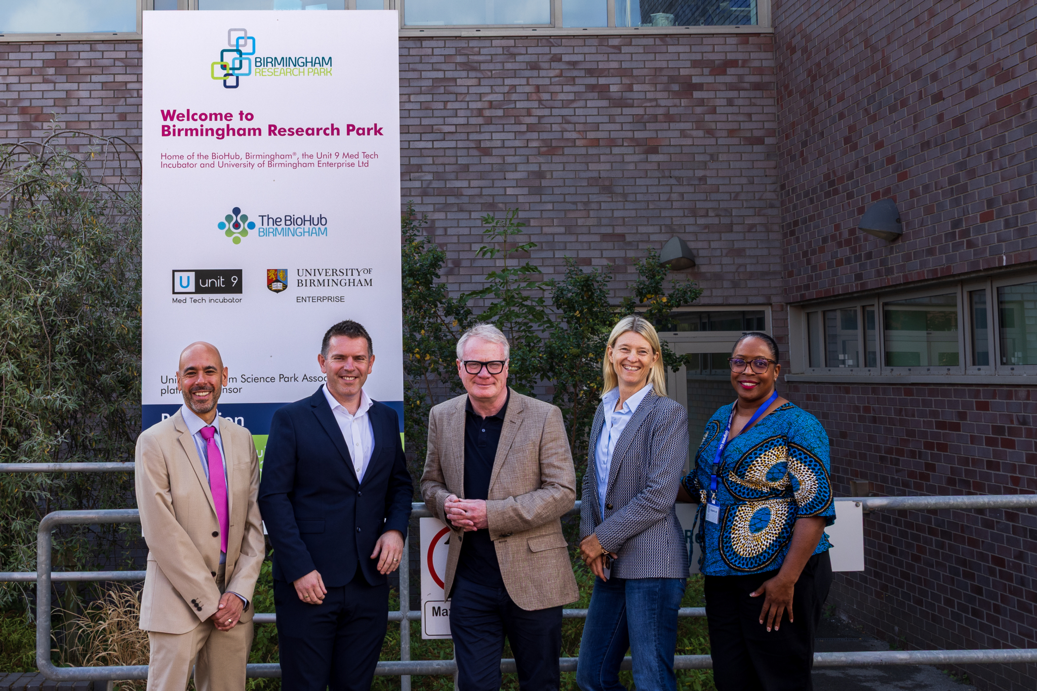 A photo showing: David Colman, CEO, University of Birmingham Enterprise Dr Richard Williams, CEO, Healome Therapeutics Ltd Richard Parker, Mayor of the West Midlands Dr Lisa Smith, CEO, Midlands Mindforge Claudia Whyte, Sjogren's UK outside the BioHub at the University of Birmingham